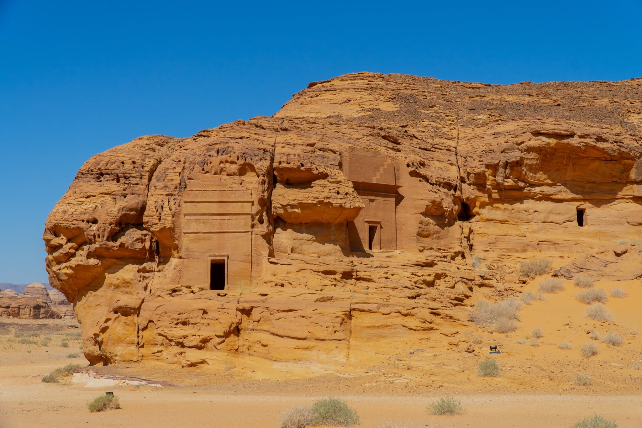 Eroded sandstone formations under the Hegra sun