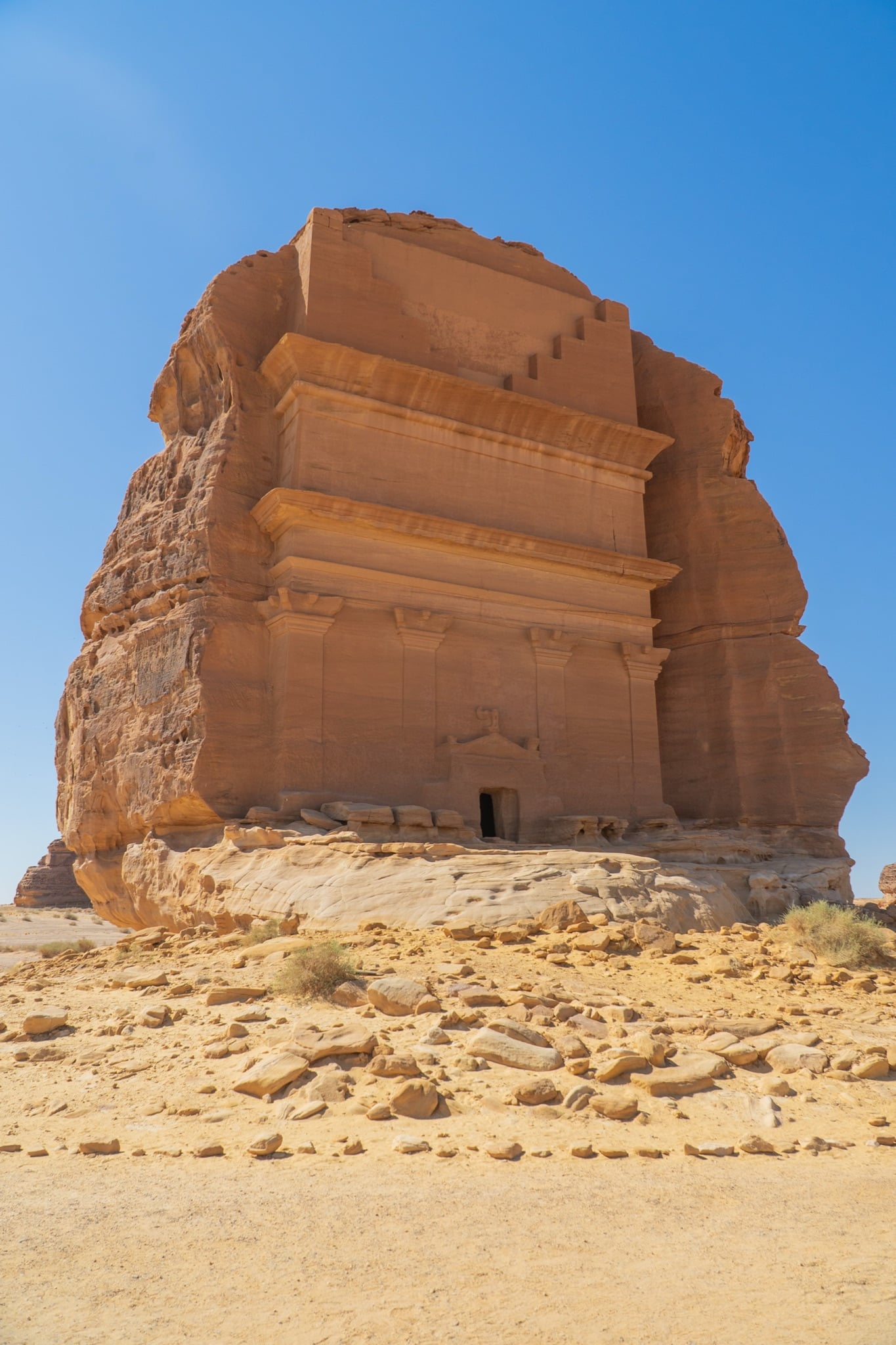 A carved tomb entrance in the Hegra sandstone