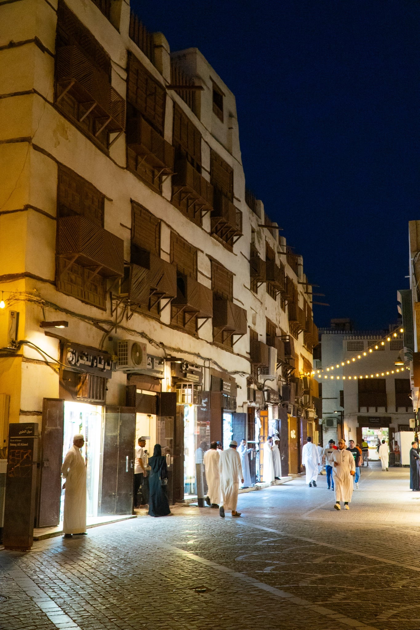 A lamplit lane in the old coral-stone quarter of Al-Balad