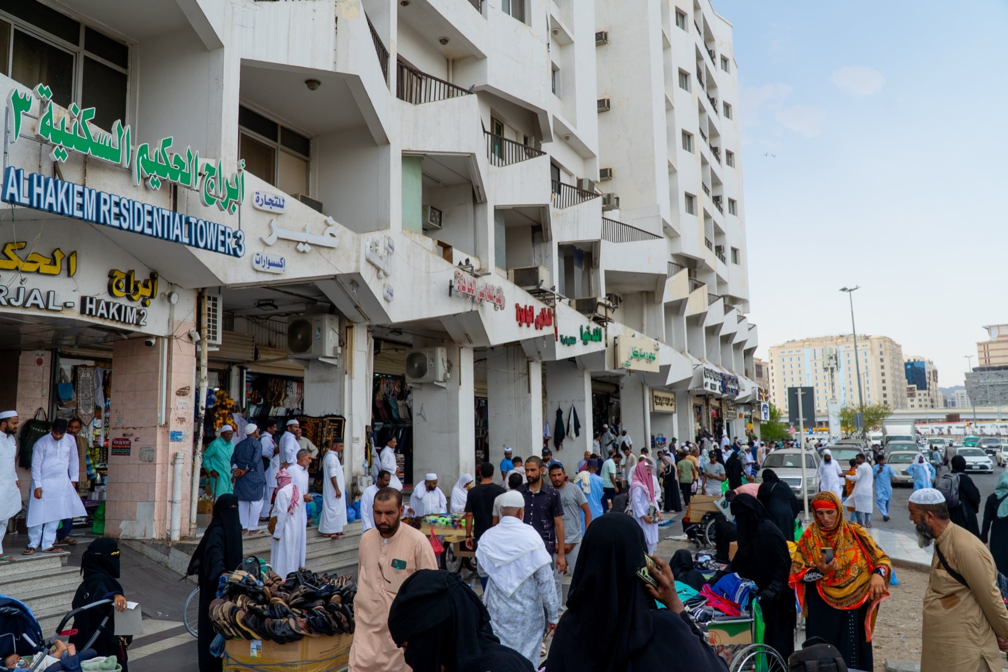 A shopping street busy with pilgrims in Madinah