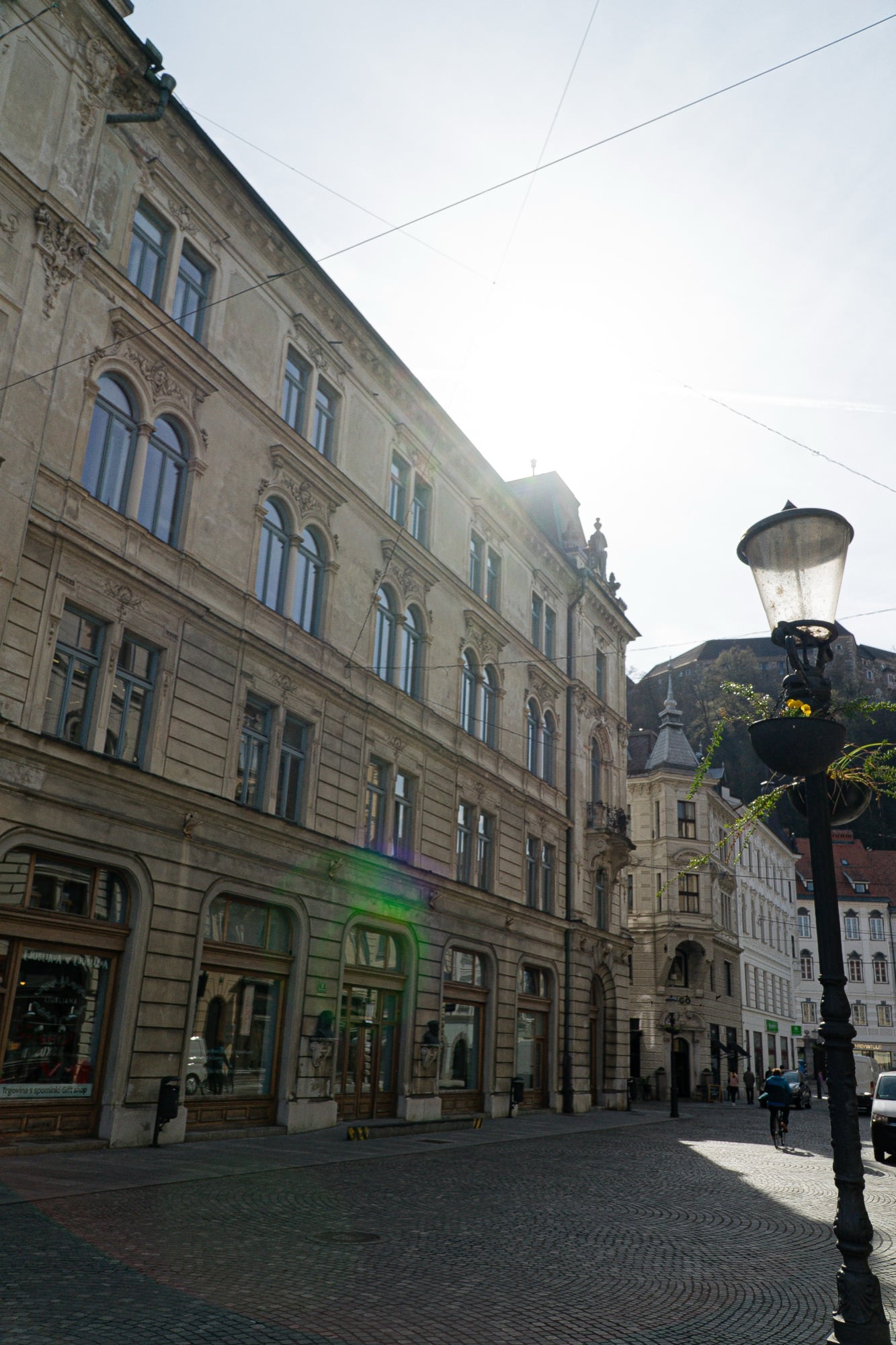 A quiet old-town street receding between pastel facades, Ljubljana