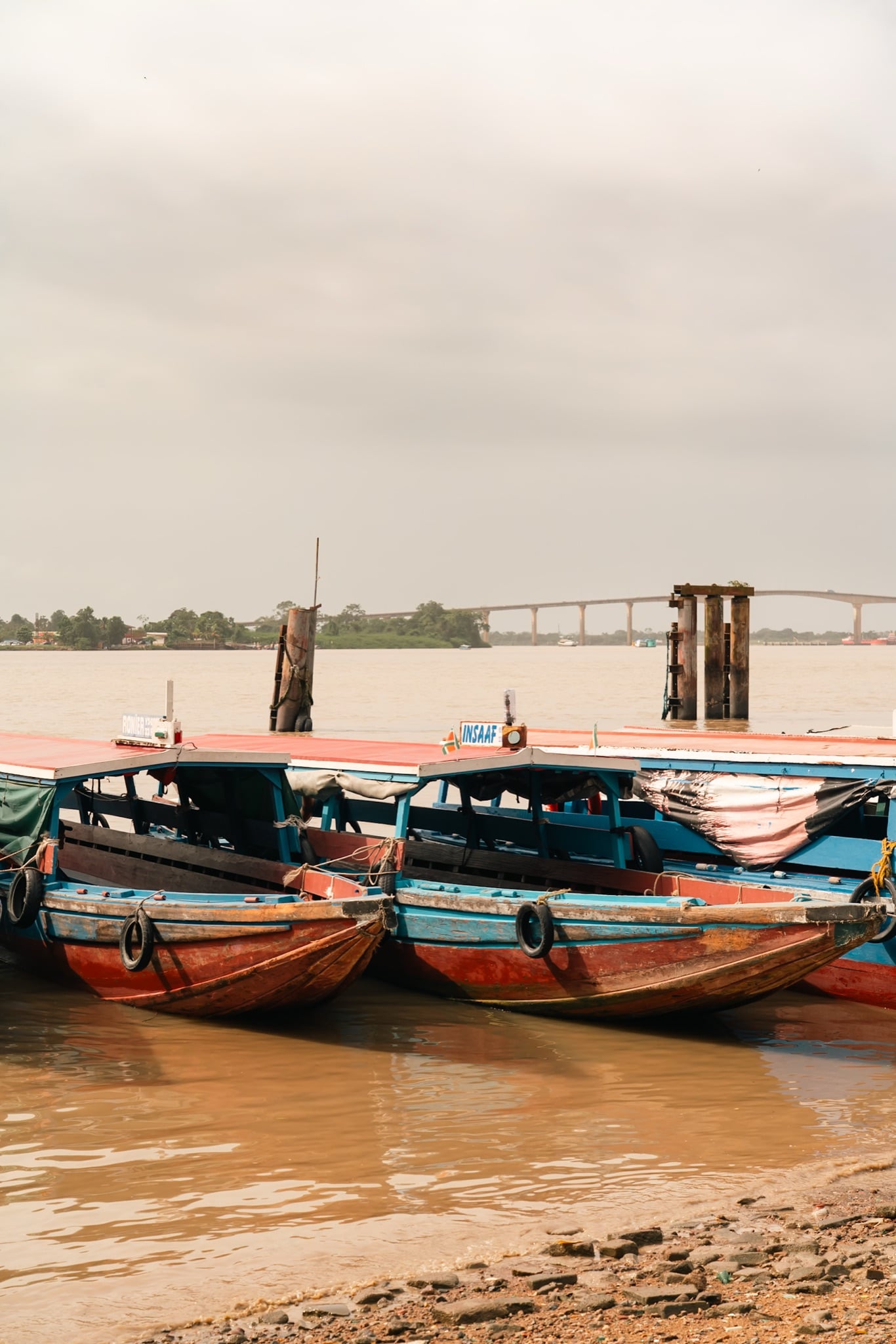 Colorful wooden passenger boats moored on the Suriname River at Paramaribo