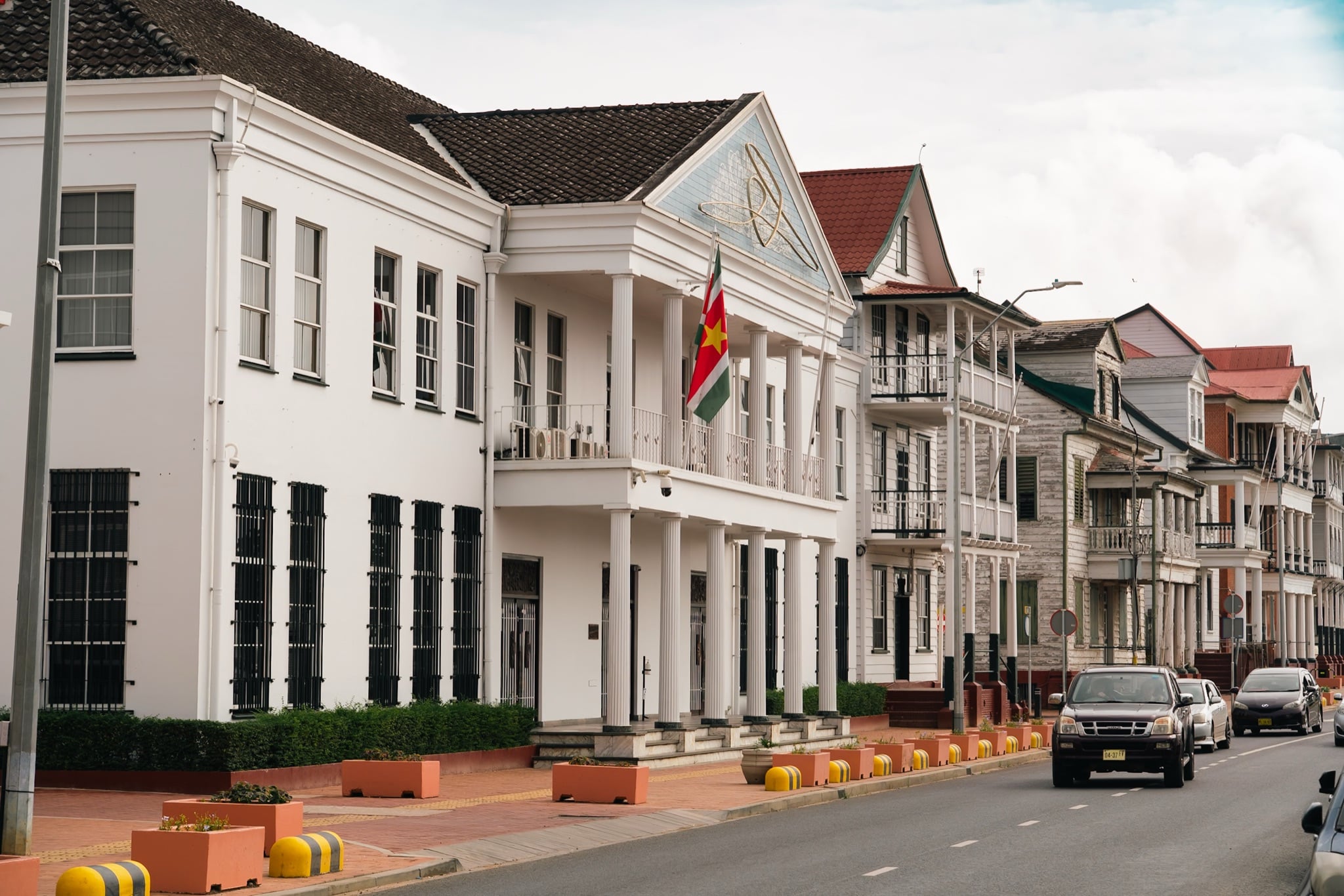 A waterfront street busy with traffic in Paramaribo