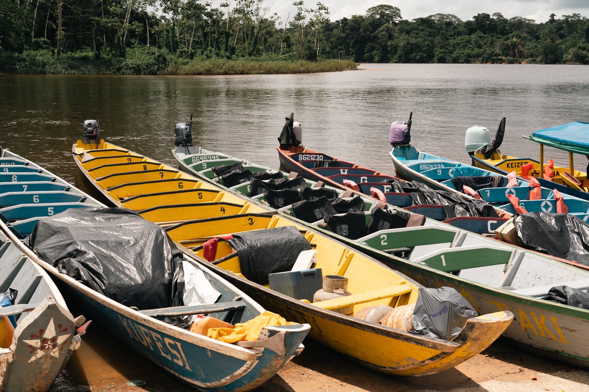 Wooden boat drifting along a Surinamese river