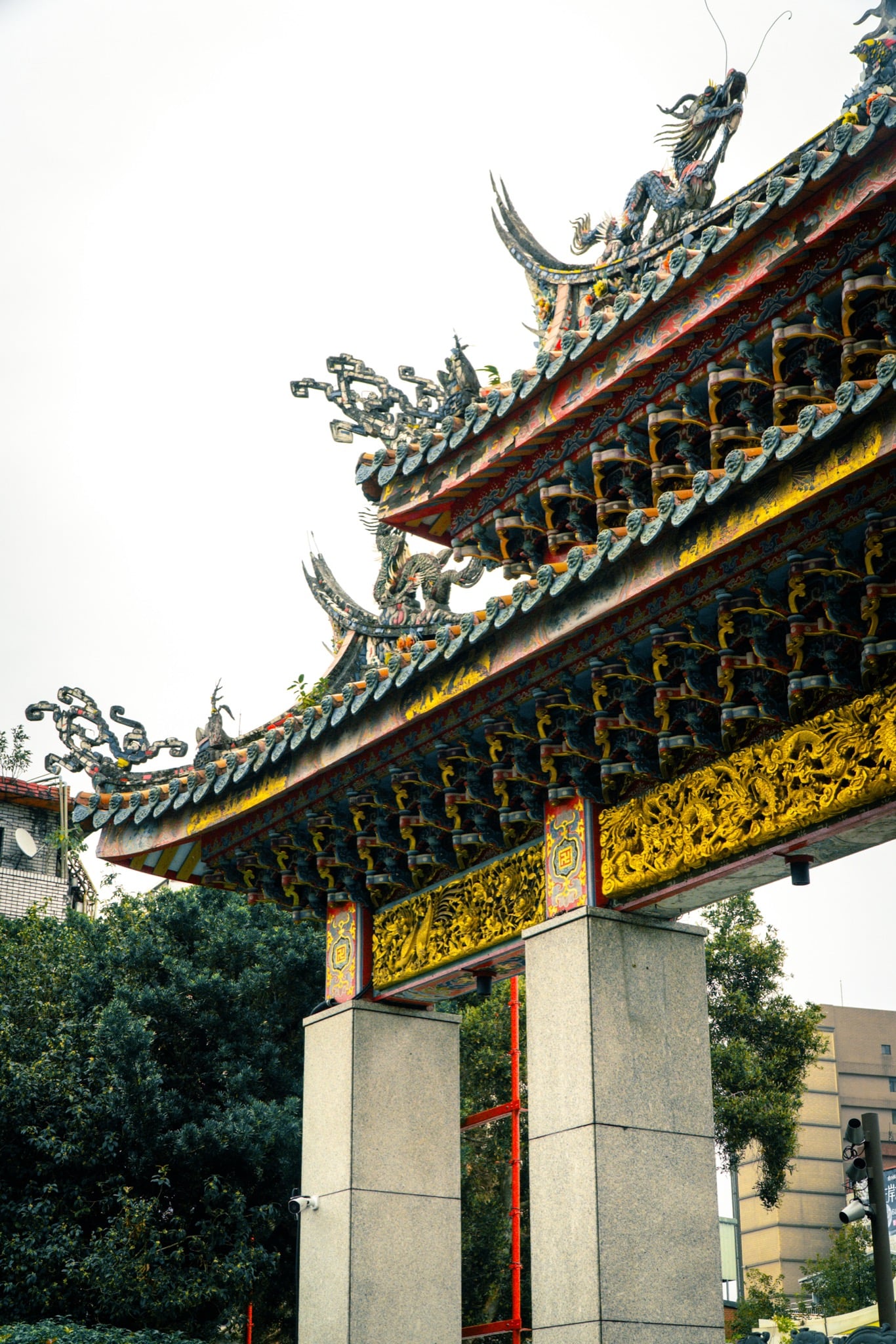The ornate roofs of Lungshan Temple rising above the incense haze, Taipei