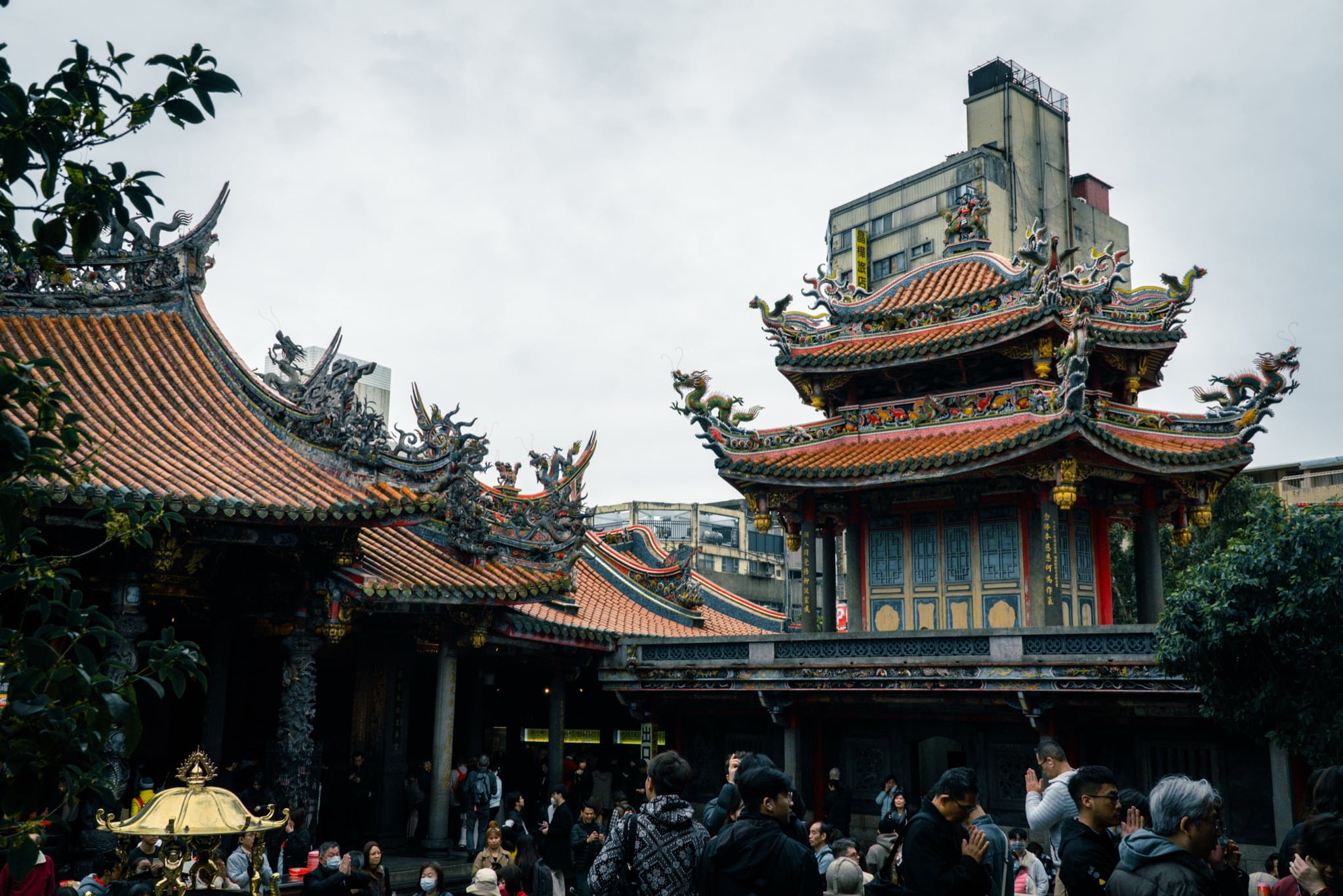 Offerings and candlelight before the main hall of Lungshan Temple, Taipei