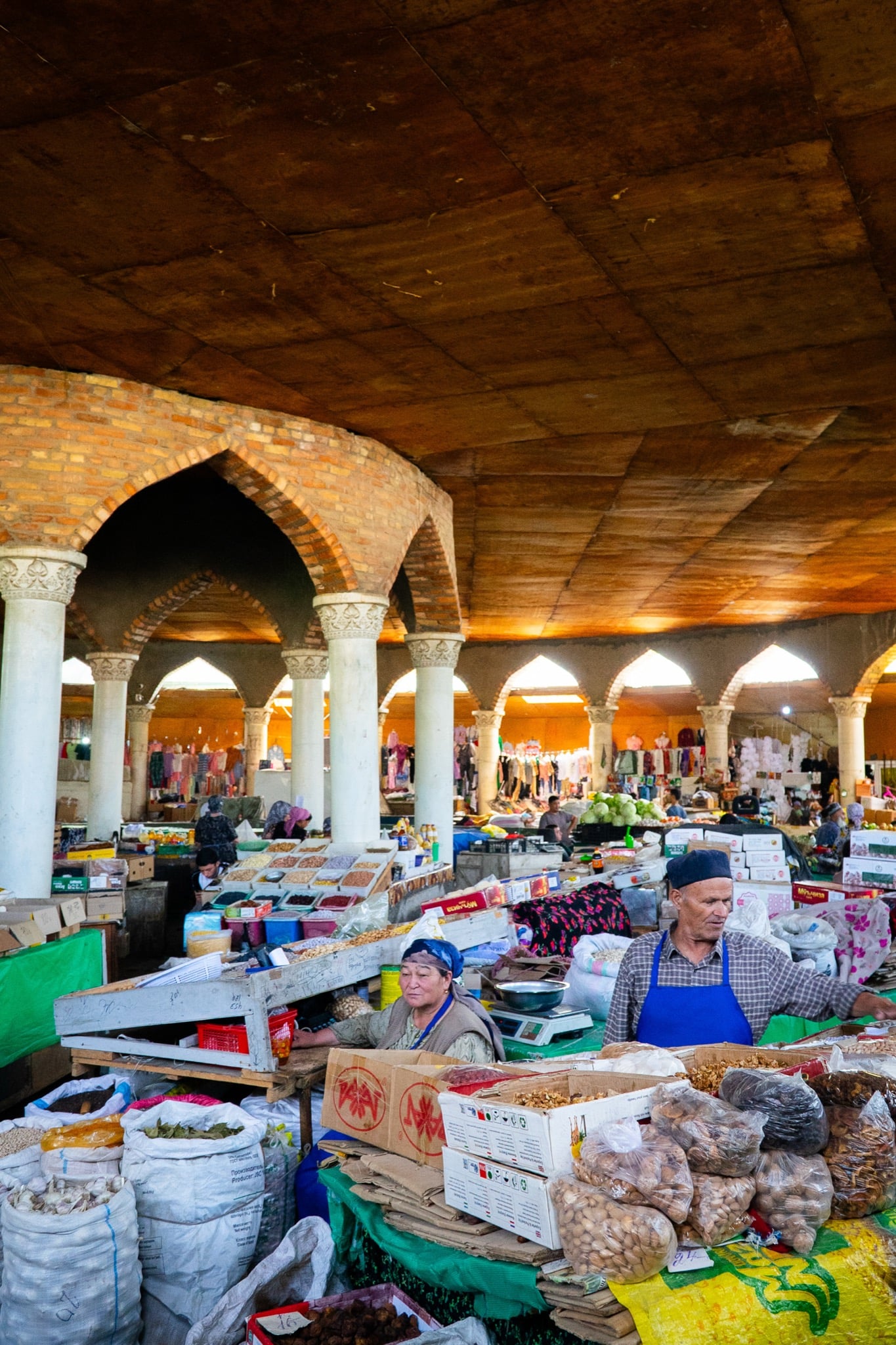 A vendor behind the counter at the Panjakent central market