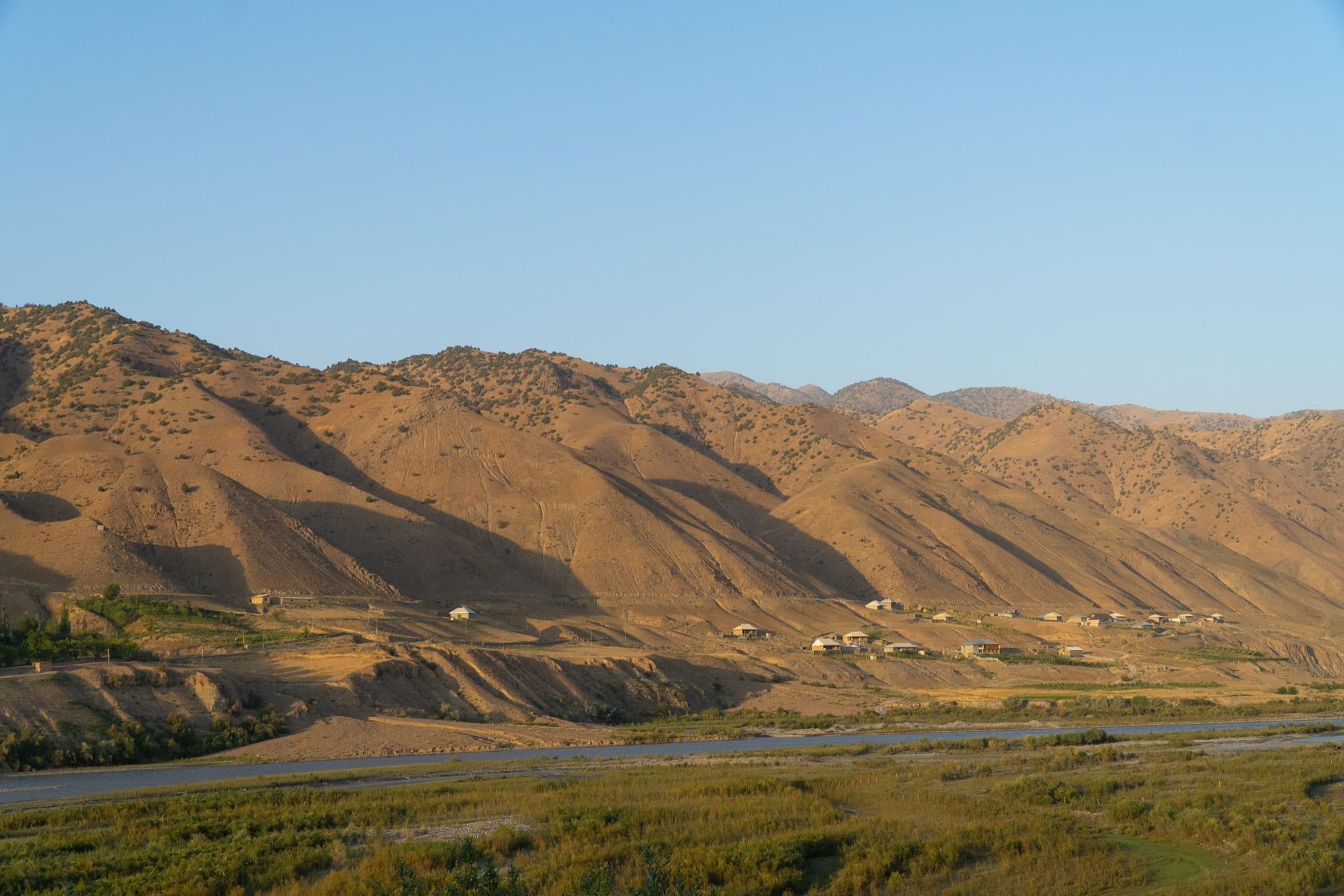 A village scattered across the golden foothills at dusk, Dashtikozy