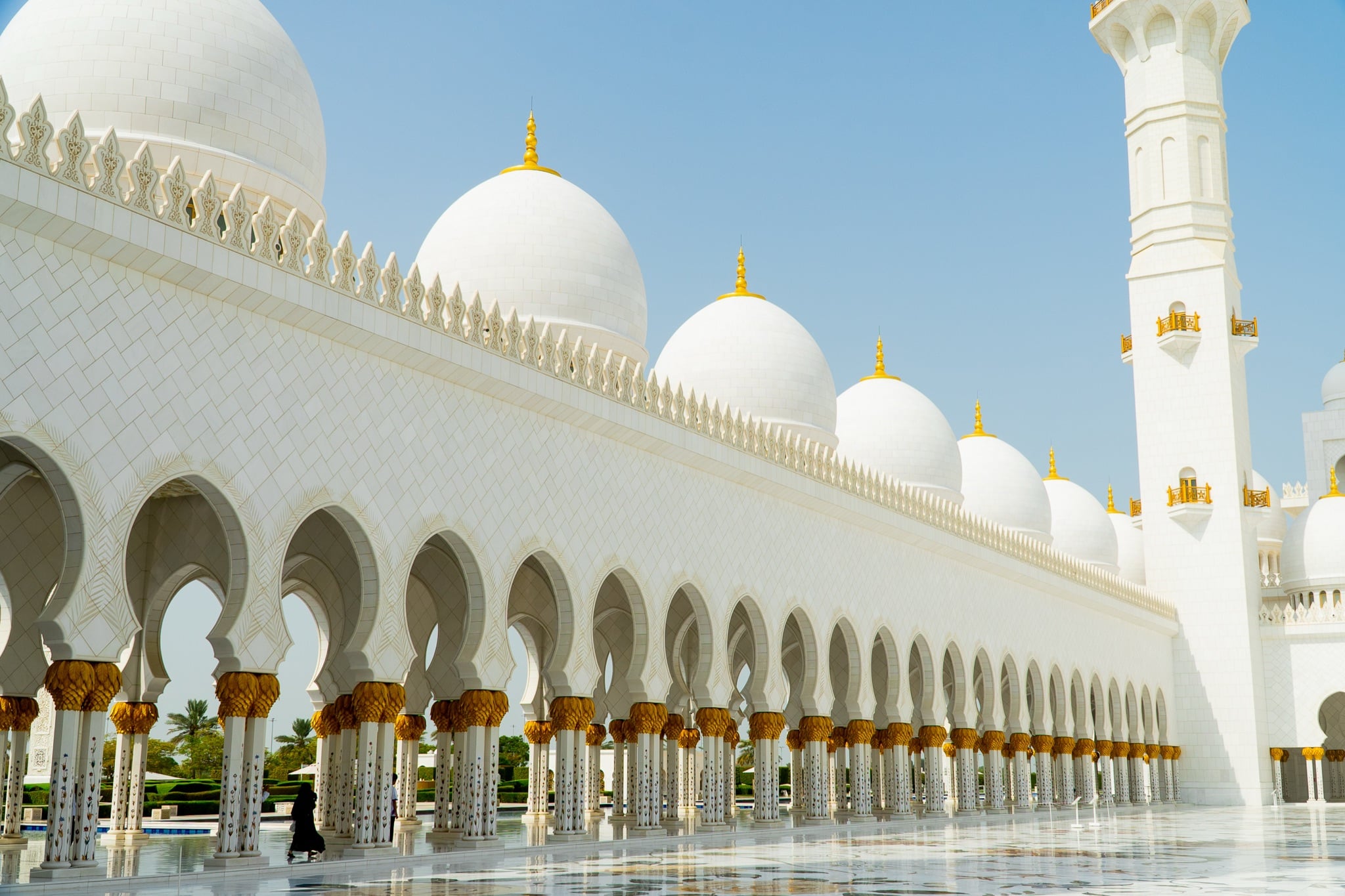 The mosque's colonnade receding along the courtyard edge
