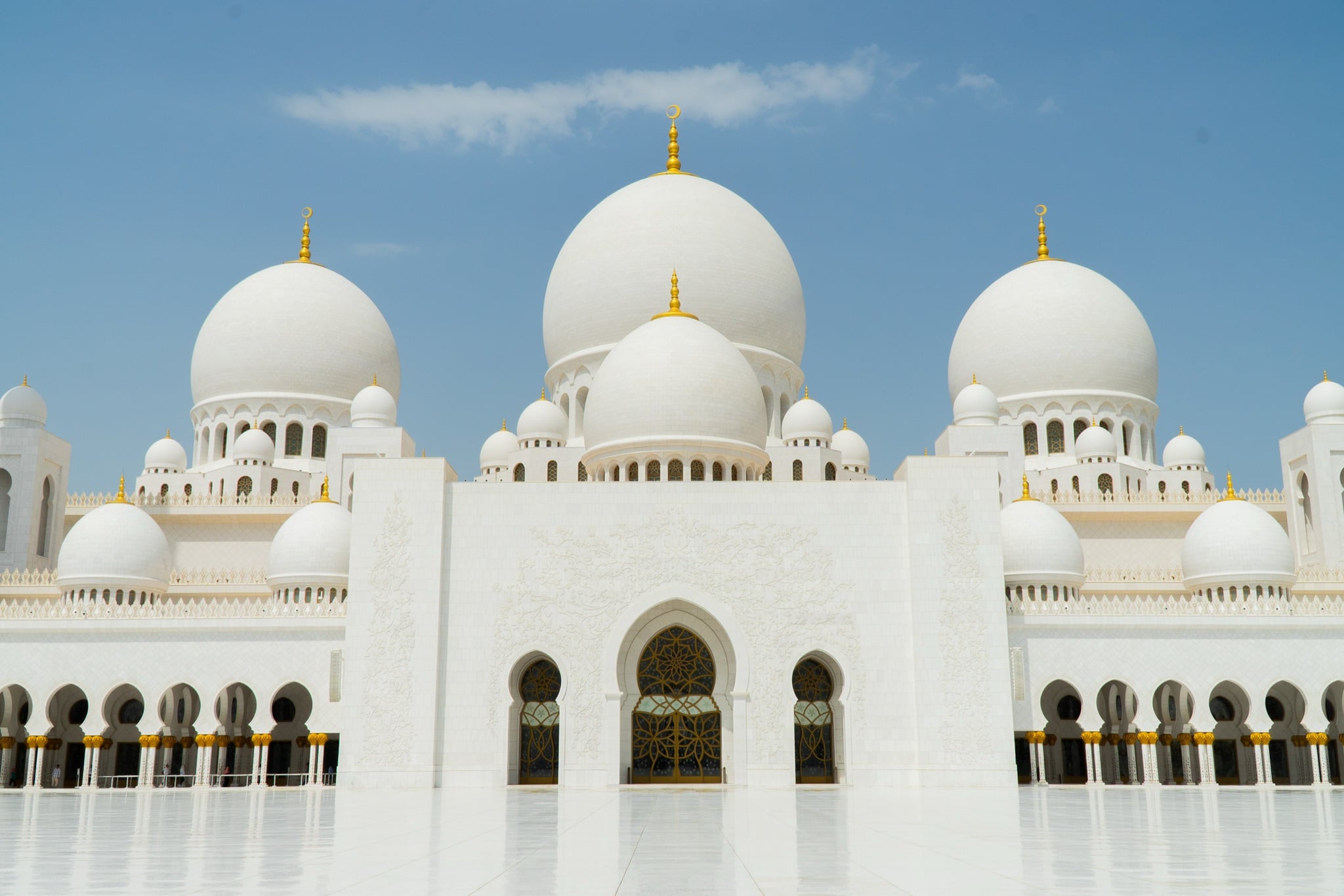 The mosque's grand entrance arch flanked by domes