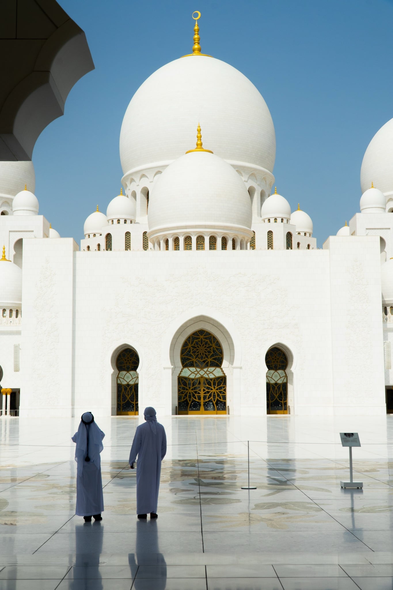 Carved white columns of the mosque courtyard in sunlight
