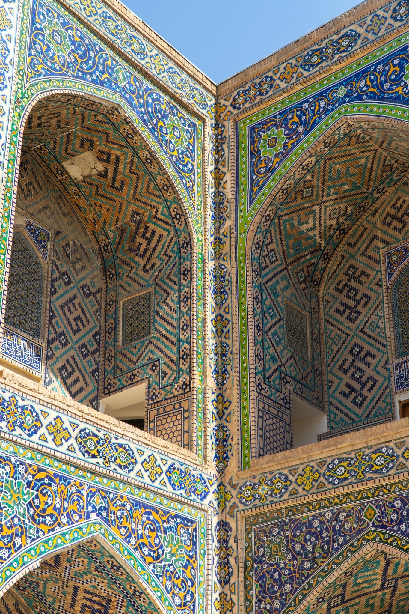 Mosaic patterns climbing a Registan Square iwan, Samarkand