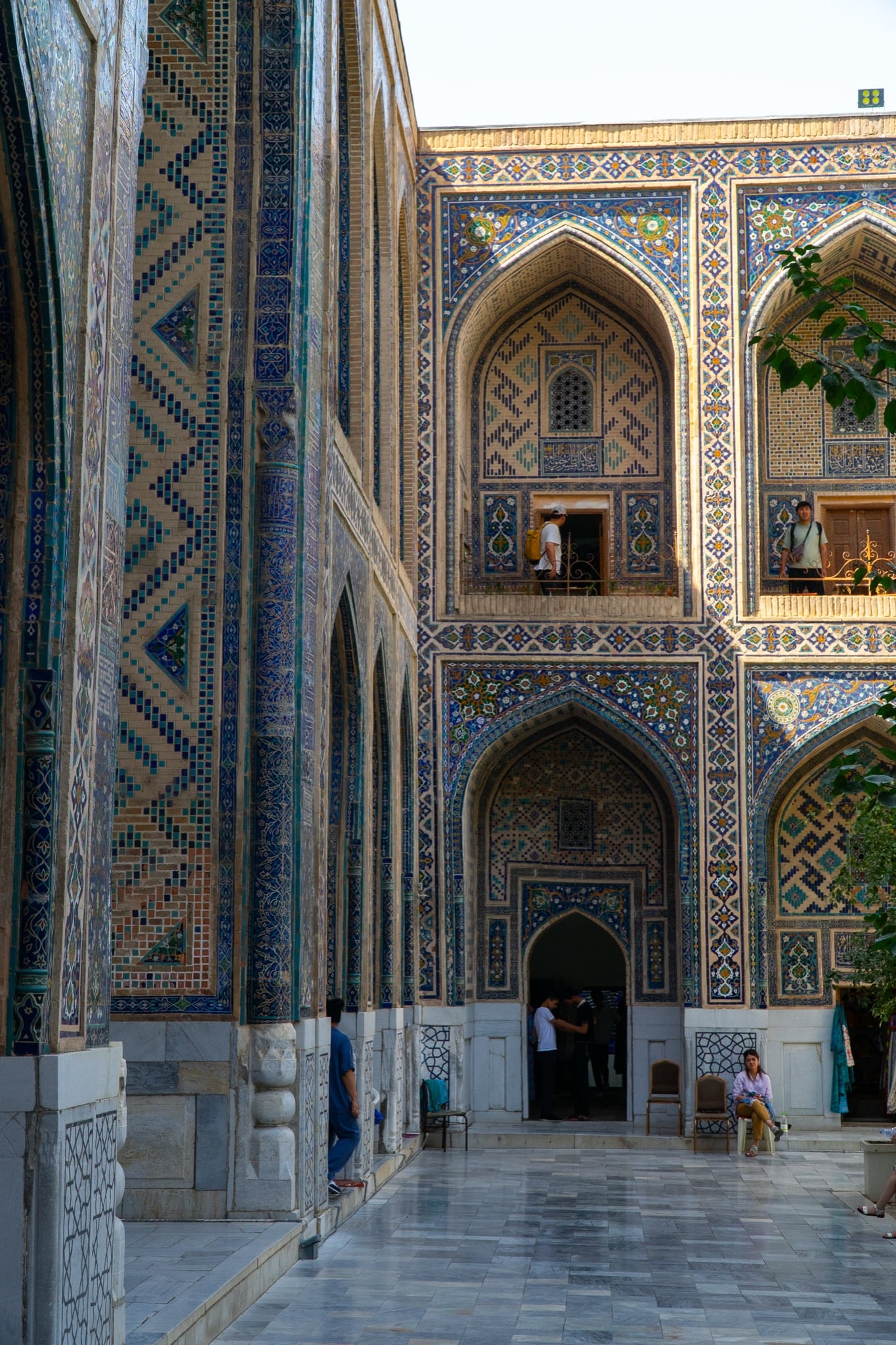 Visitors crossing the plaza at Registan Square, Samarkand