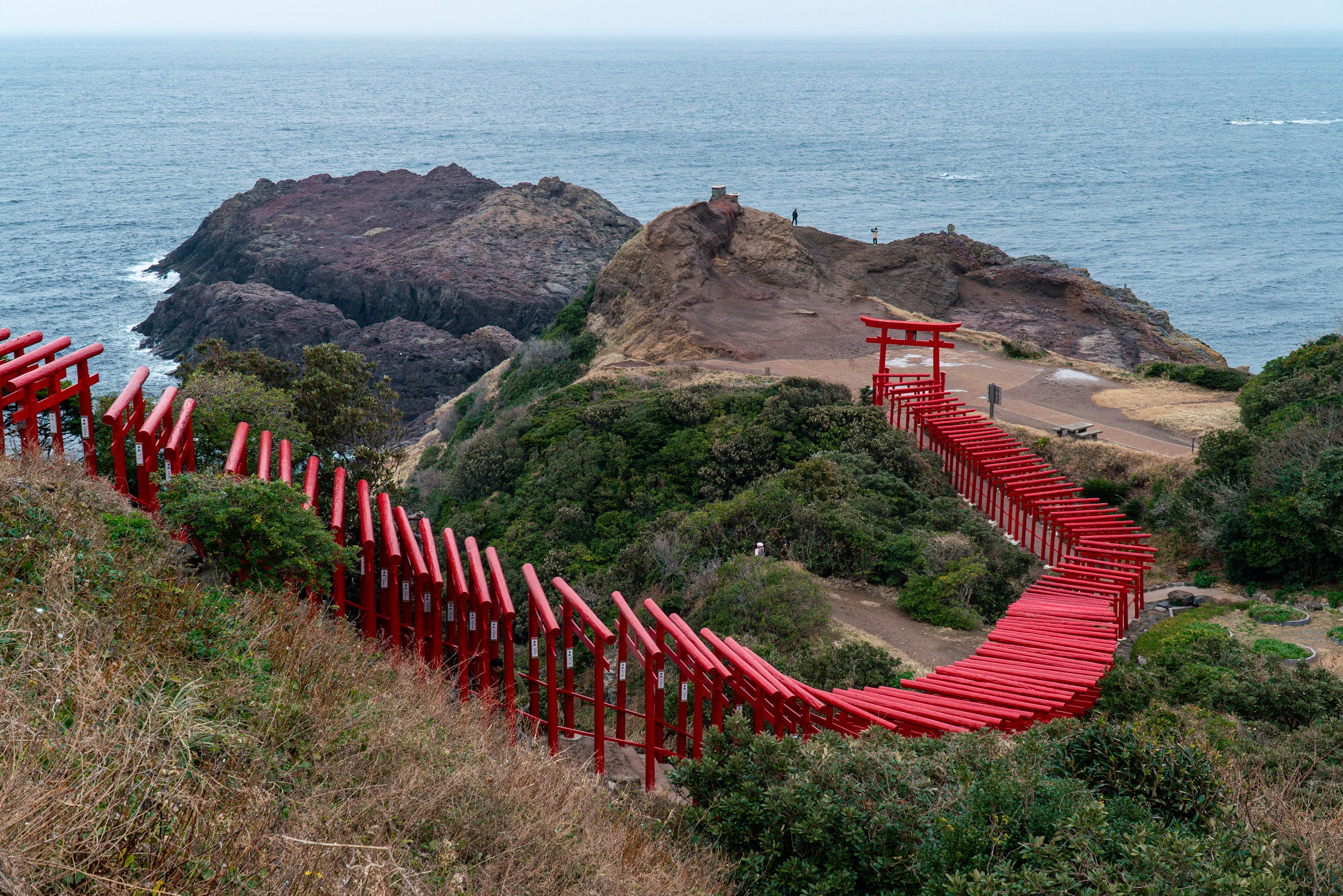 Torii gate standing at the edge of the sea